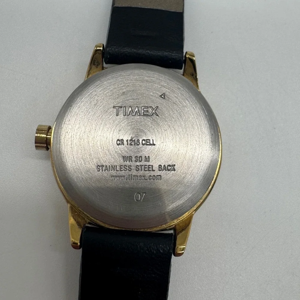 Timex Indiglo WR 30M Gold Tone White Dial Black Leather Watch CR 1216 needs bat